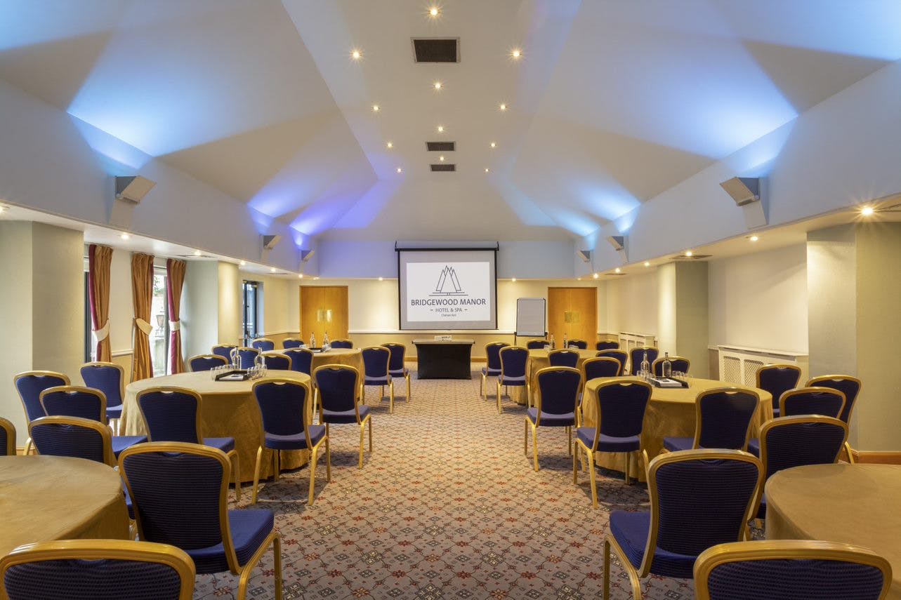 Hythe Suite conference room with round tables, ideal for corporate events and workshops.