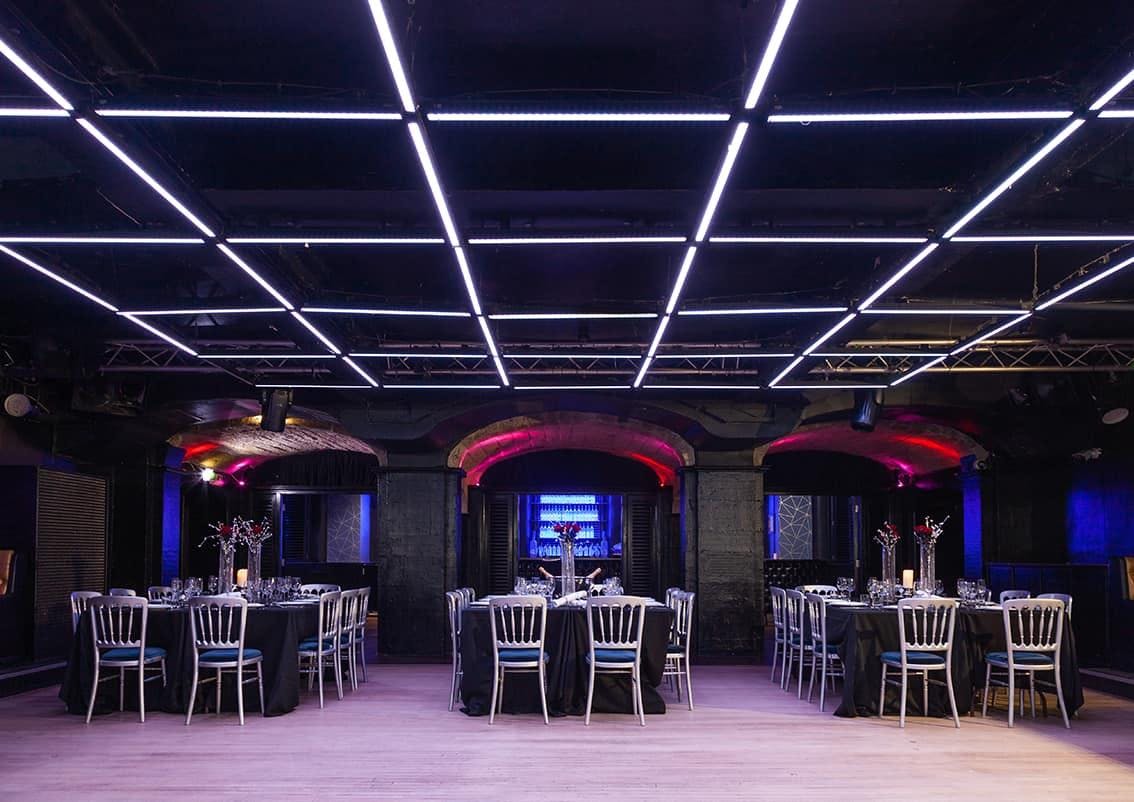 Modern event space at Why Not Nightclub with illuminated ceiling panels for corporate gatherings.