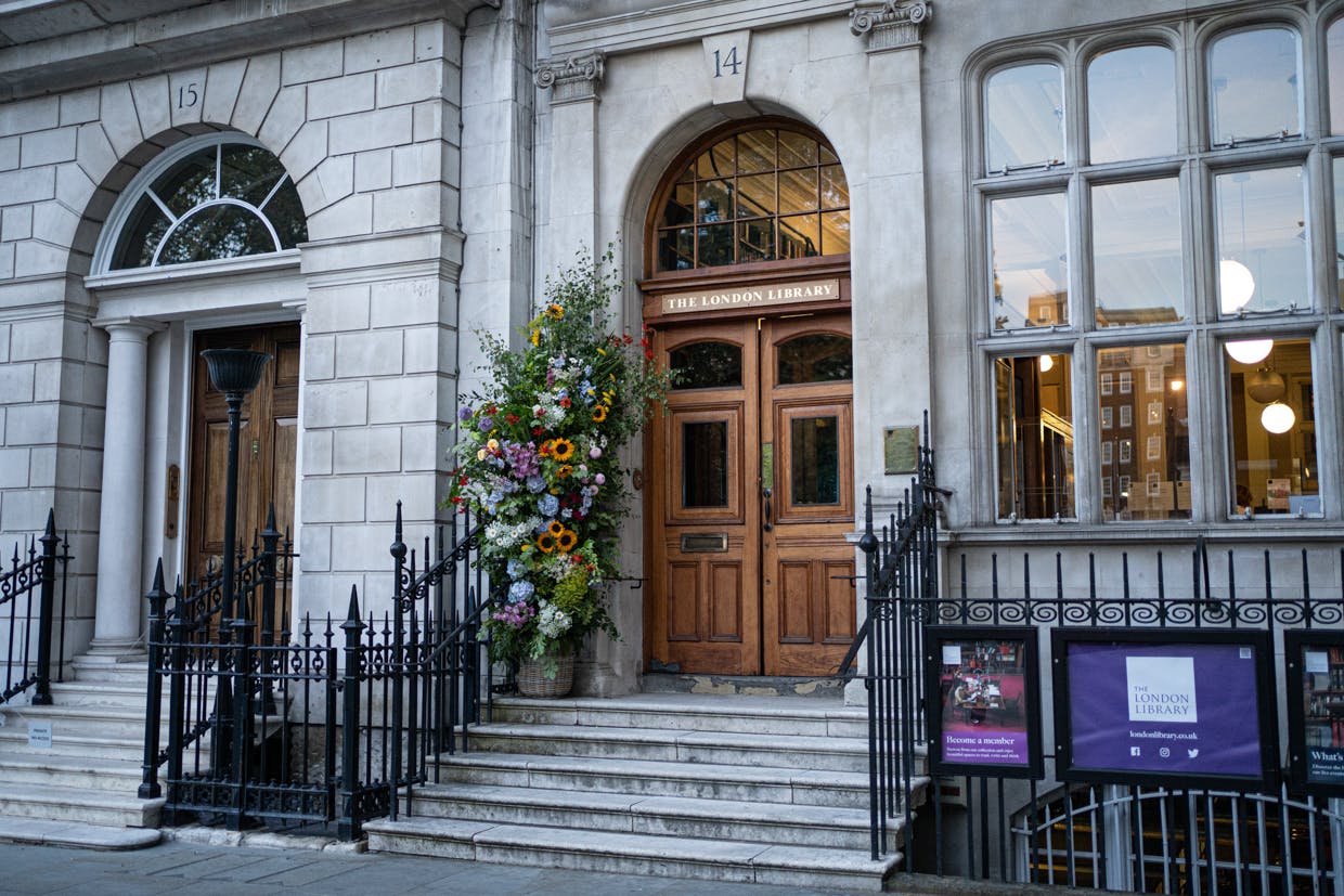 Elegant venue entrance with grand wooden doors, perfect for upscale events and gatherings.