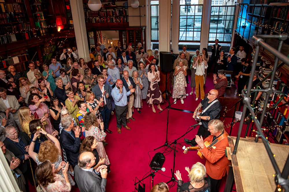 Vibrant event at The London Library with elegant decor and live music for networking. - Banner