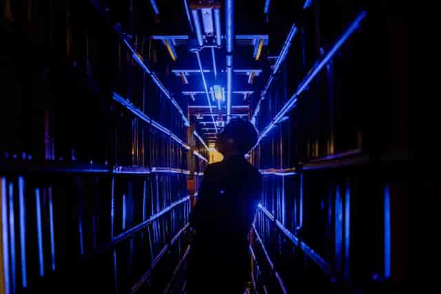 Illuminated blue corridor in The London Library, ideal for unique networking events.