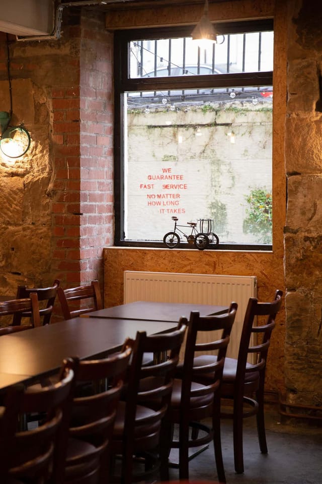 Cozy rustic meeting space with wooden tables for private venue hire events.