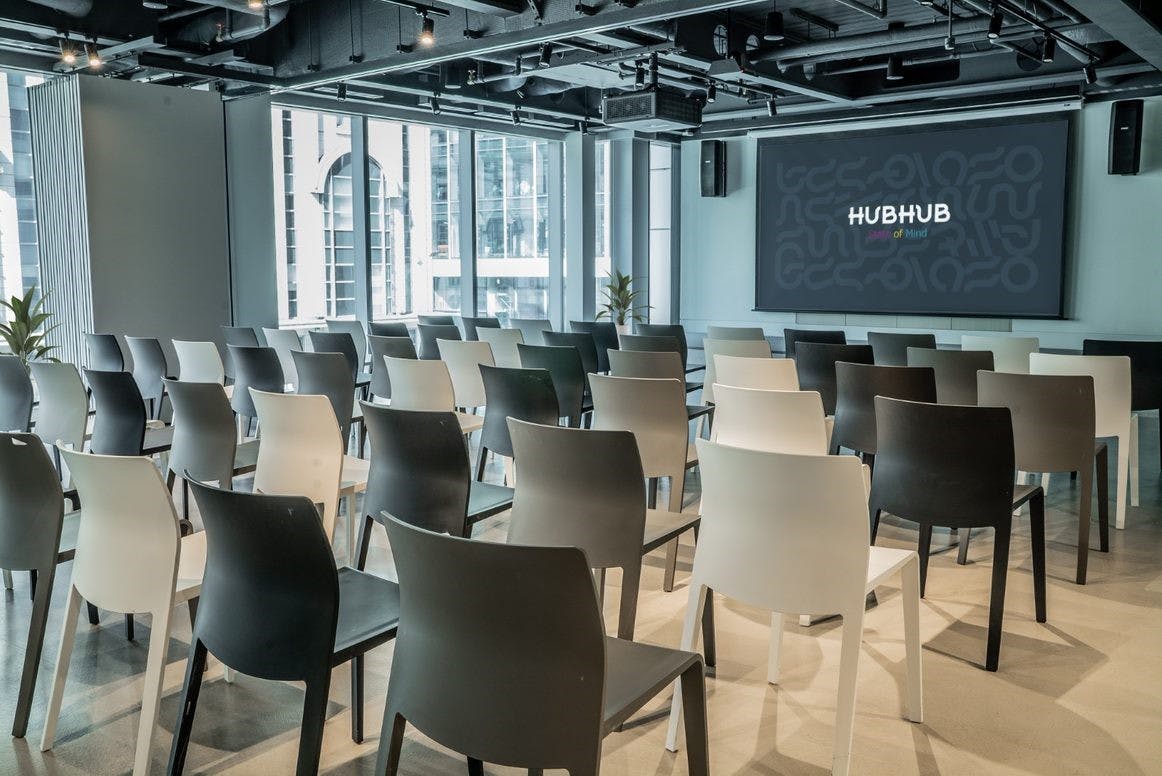 Modern business lounge event space with minimalist chairs for presentations and workshops.