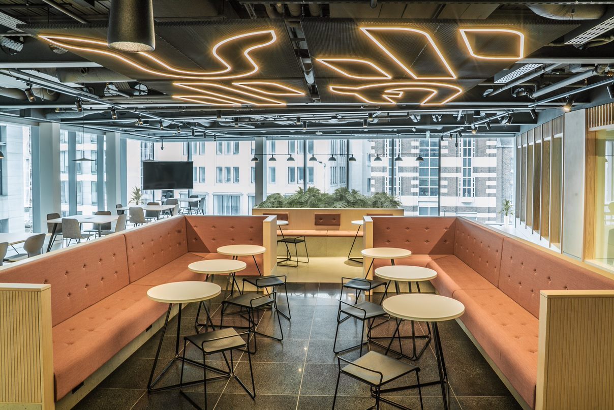 Modern business lounge with flexible seating for meetings and networking events. - Banner