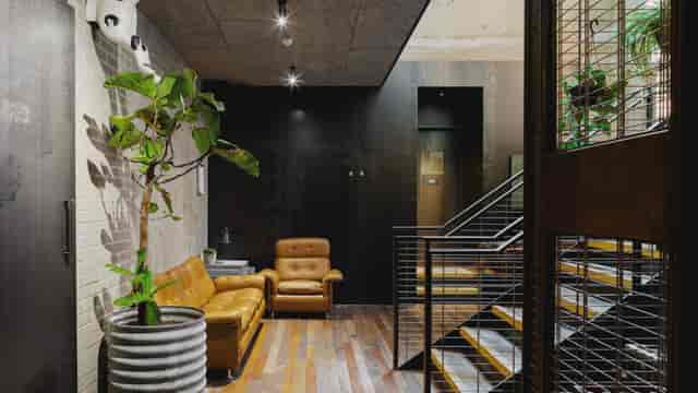 Modern lobby at Heist Bank, featuring warm wood tones for networking events.