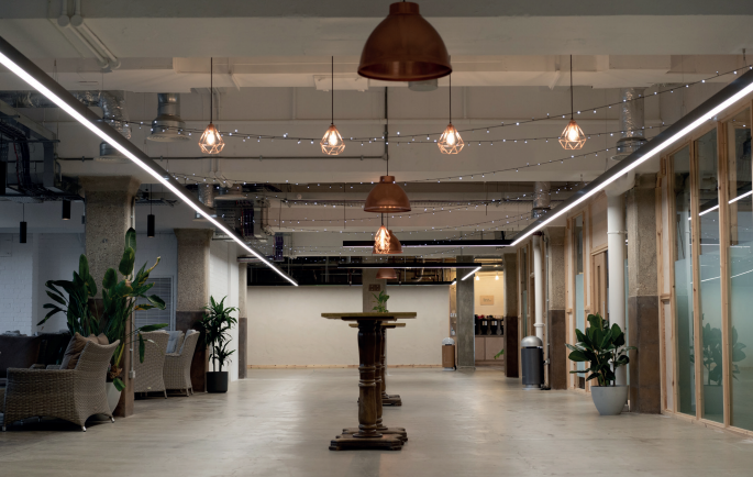 Spacious, well-lit second floor venue with modern design for meetings and events.