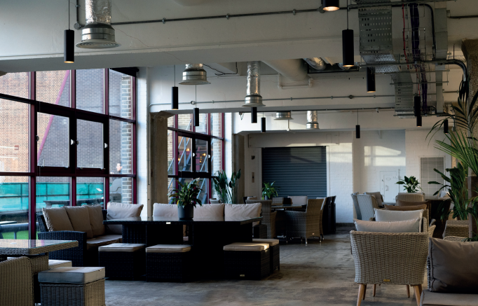 Modern lounge area with natural light for networking events in Sustainable Workspaces.