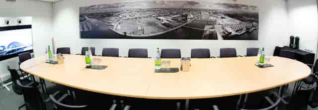Modern meeting room in Glasgow Science Centre with wooden table, ideal for professional events.