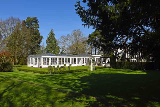 Orangery at Hayne House: glass-enclosed venue with lush garden for events and meetings.