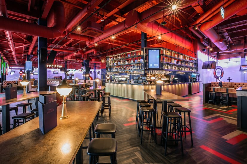 Vibrant event space with modern bar for social gatherings at Puttshack Lakeside.