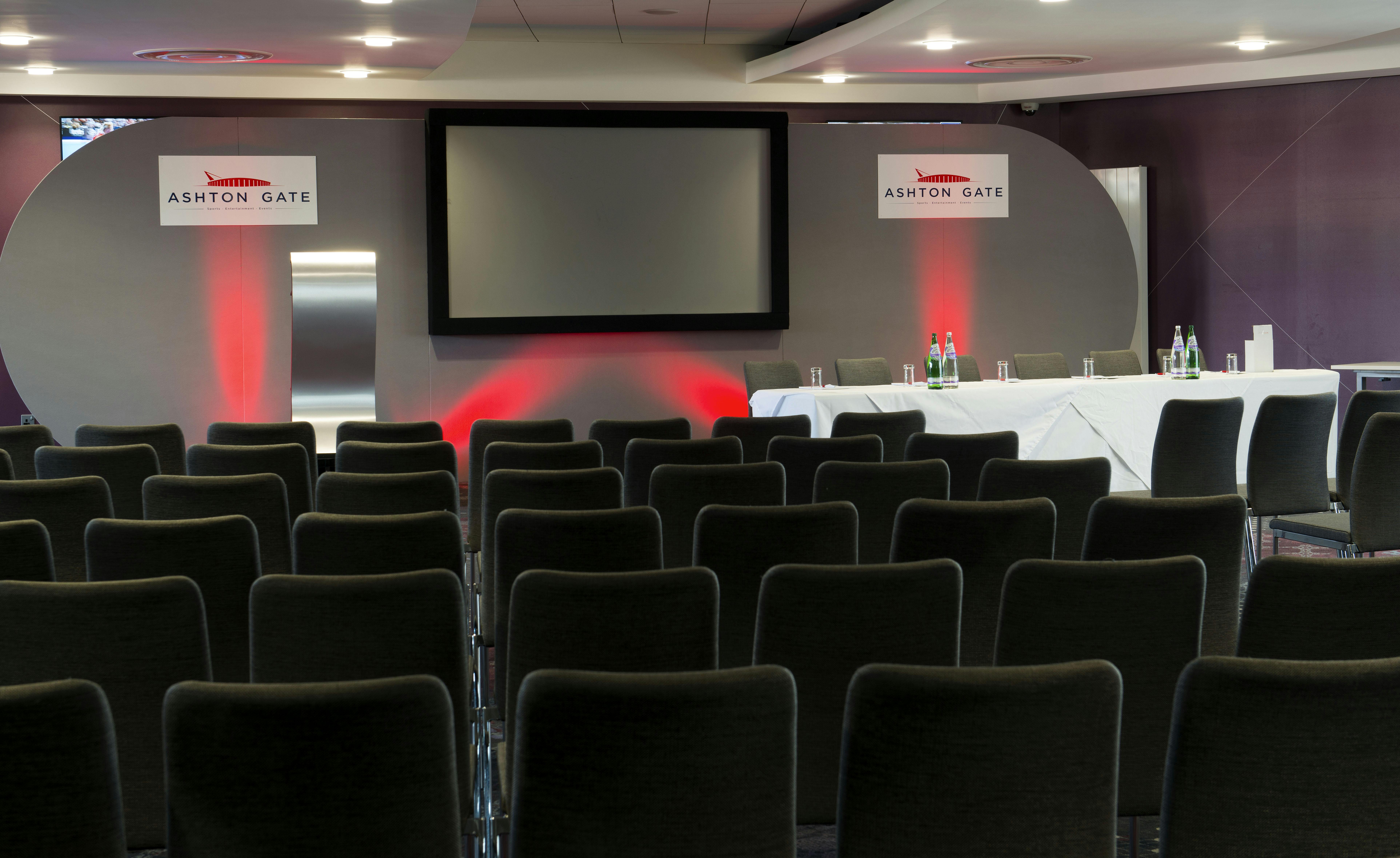 Heineken Suite at Ashton Gate Stadium, modern conference setup with black chairs.