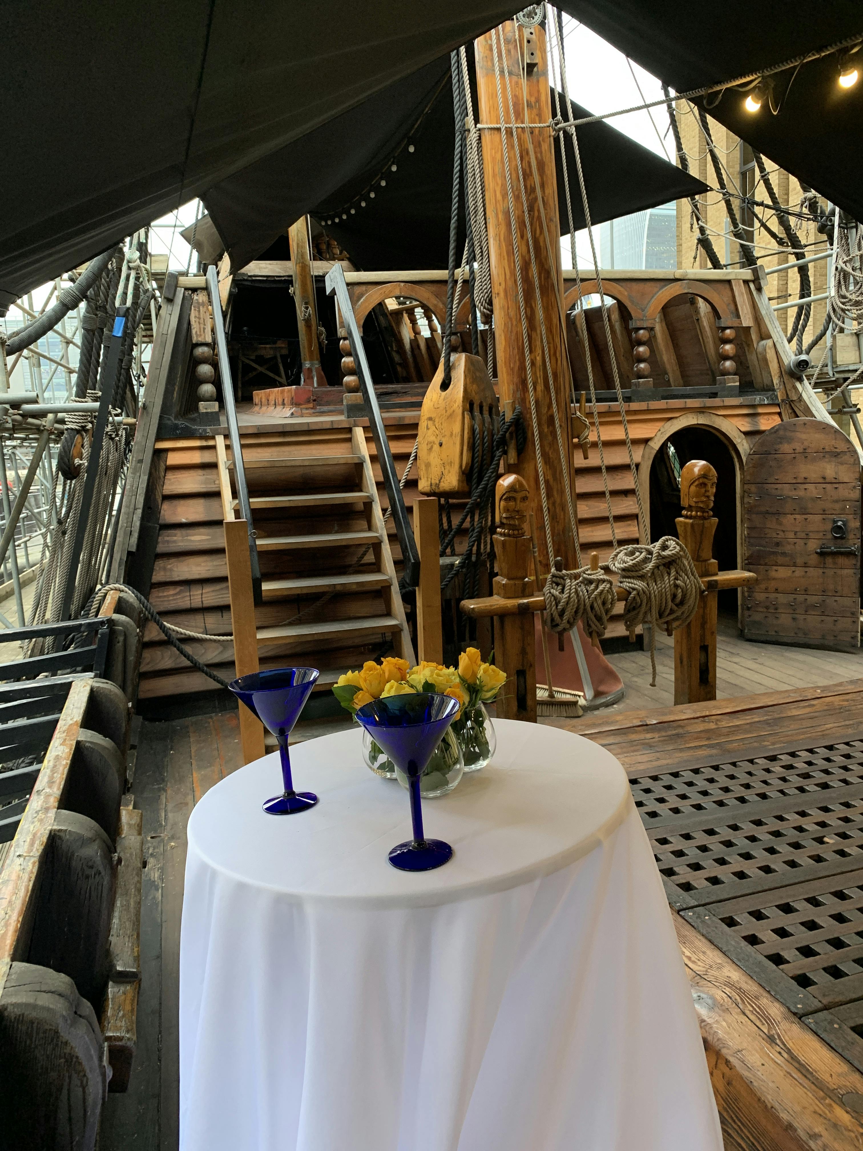 Whole Venue on The Golden Hinde: rustic ship event space with floral decor for gatherings.