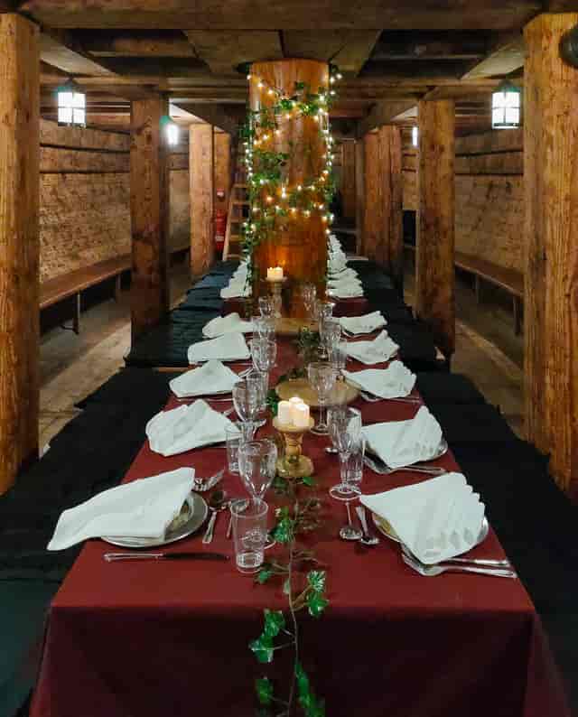 Elegant long dining table in The Golden Hinde, perfect for formal dinners and celebrations.