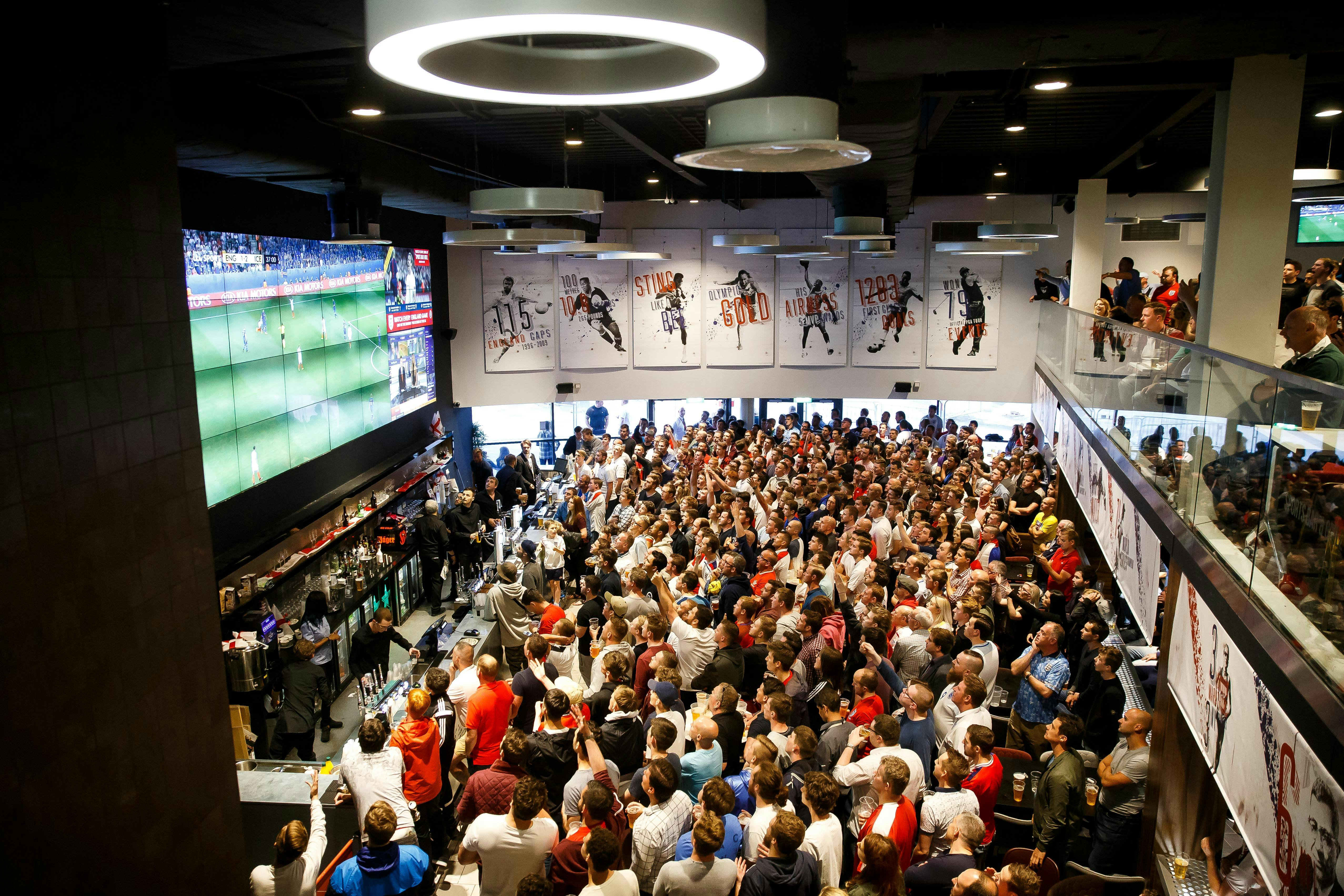 Vibrant crowd at Ashton Gate Stadium sports bar, perfect for corporate events and fan engagement.