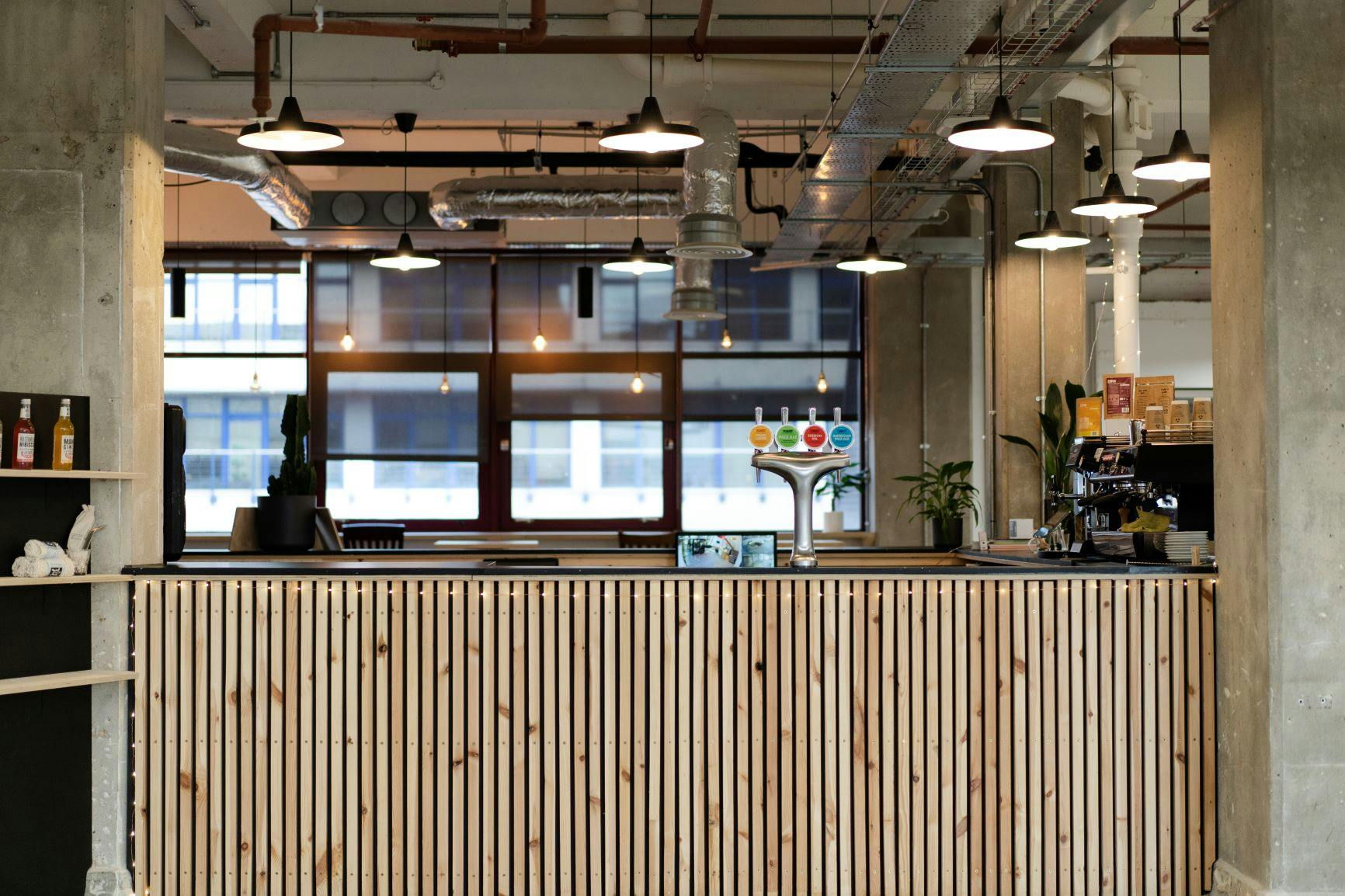 Modern reception area with wooden counter in sustainable workspace for events.