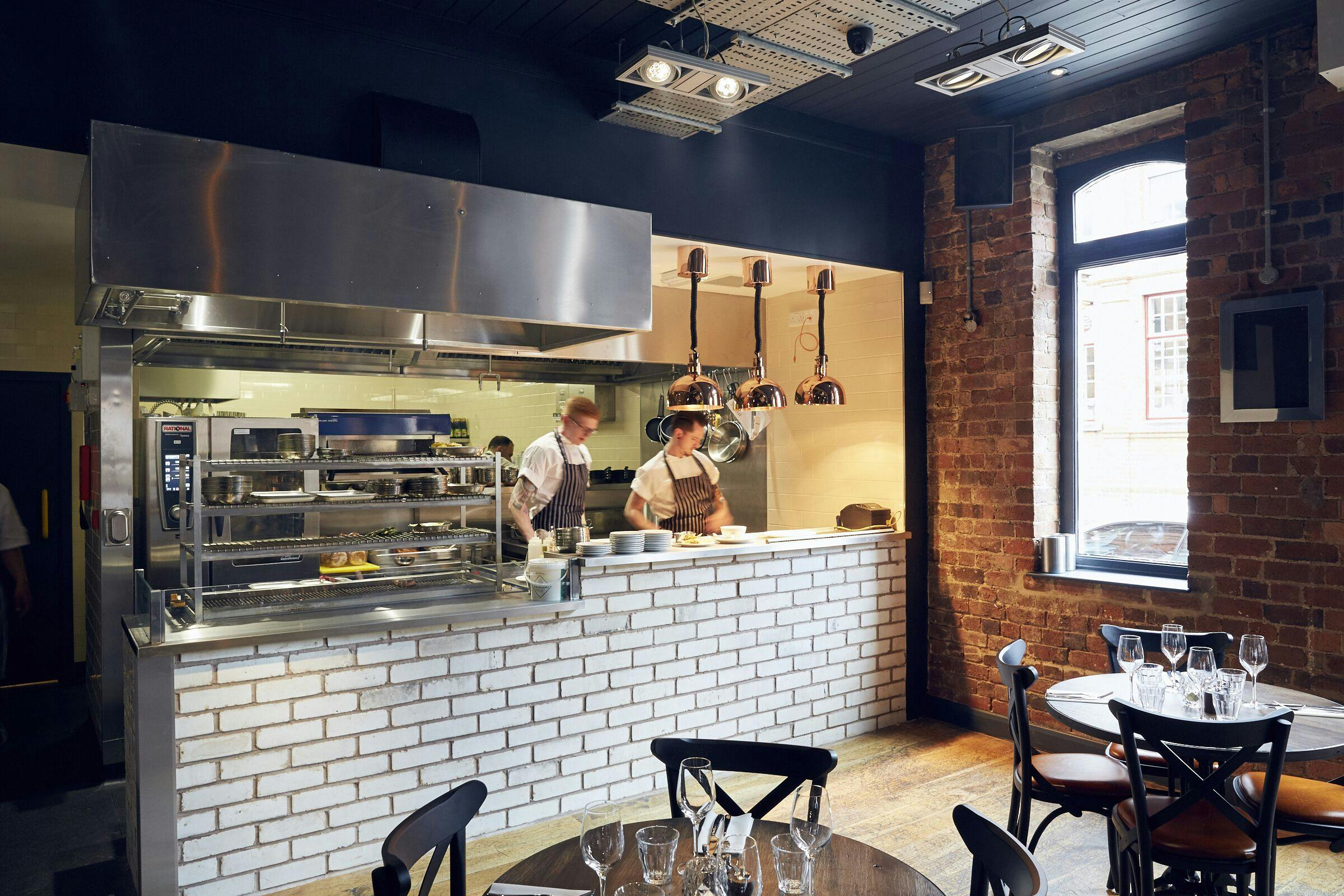Modern kitchen with stainless steel appliances for culinary events and private dining.