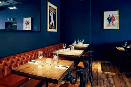 Stylish dining area with dark blue walls, perfect for intimate events and gatherings.