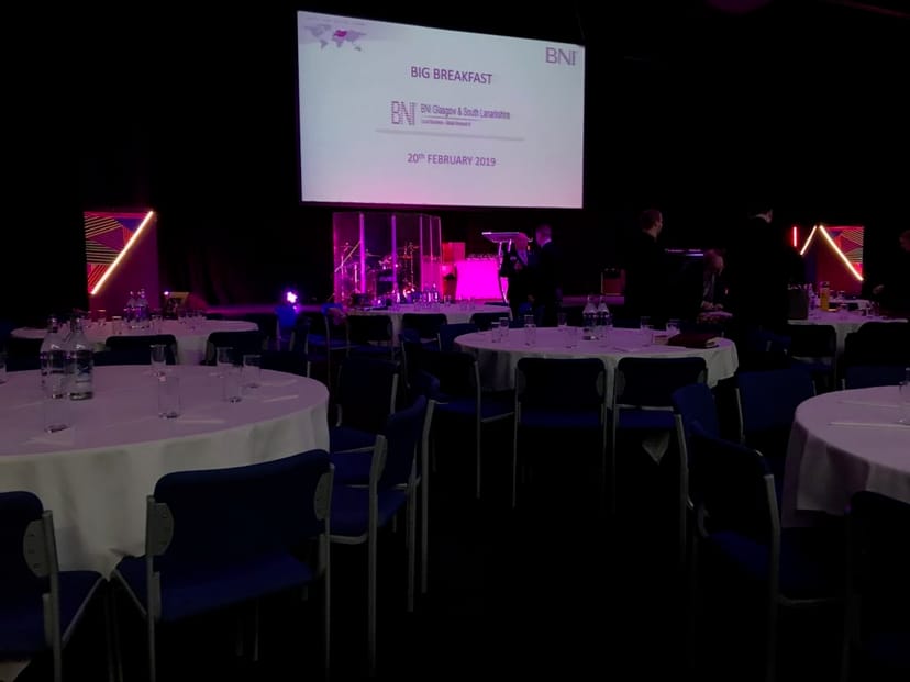 Auditorium in C7 Conference Centre set for a big breakfast meeting with elegant tables.