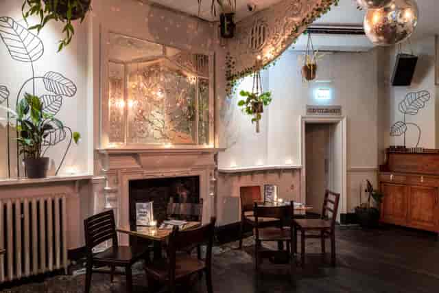 Stylish event space with warm lighting, ideal for small gatherings and meetings.