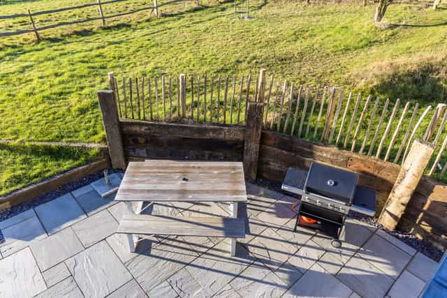 Outdoor event space at The Grain Store Lewes with rustic picnic table for summer barbecues.