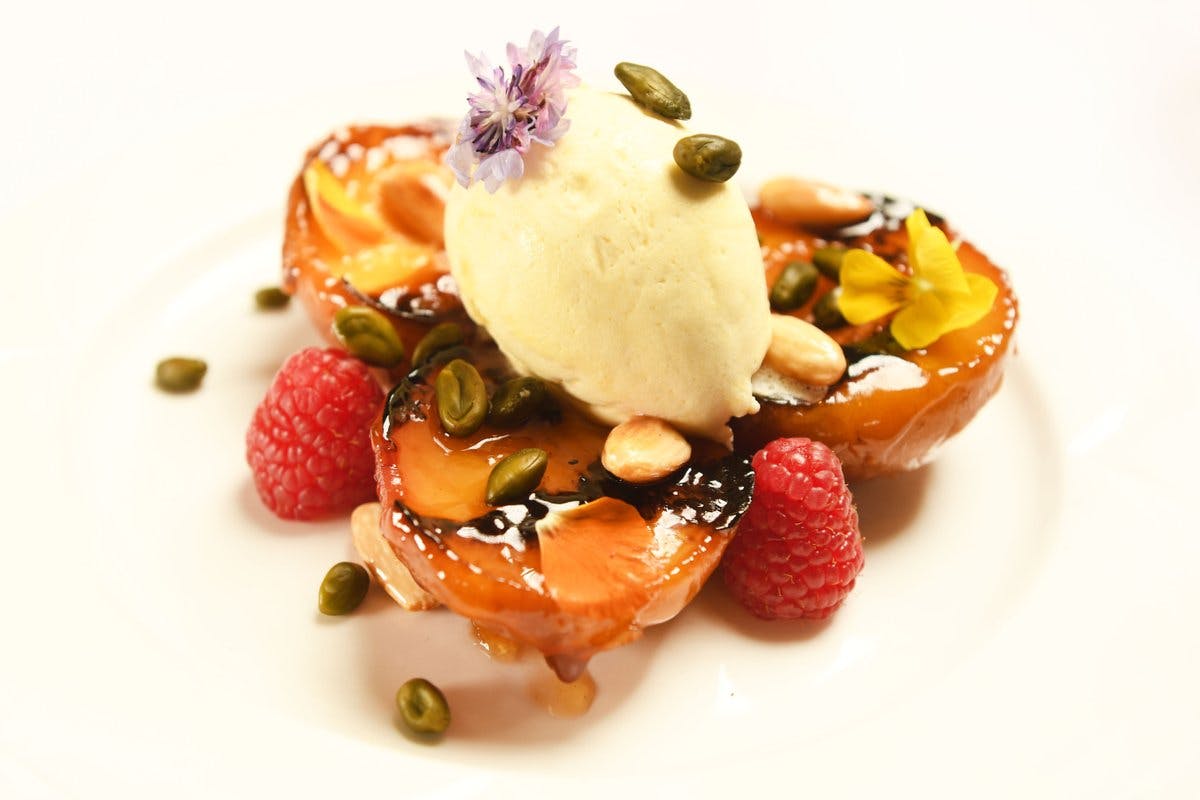 Elegant dessert with caramelized fruit at Brooklands Museum for upscale events.