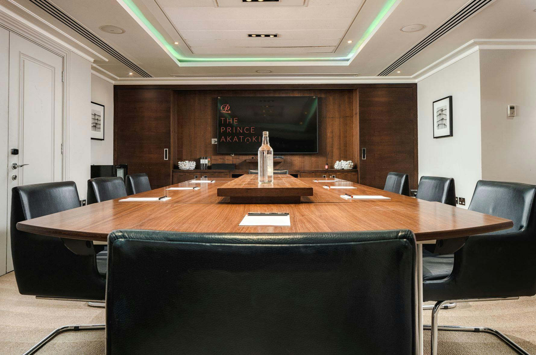 Modern meeting room with polished wooden table for corporate events in The Prince Akatoki London.