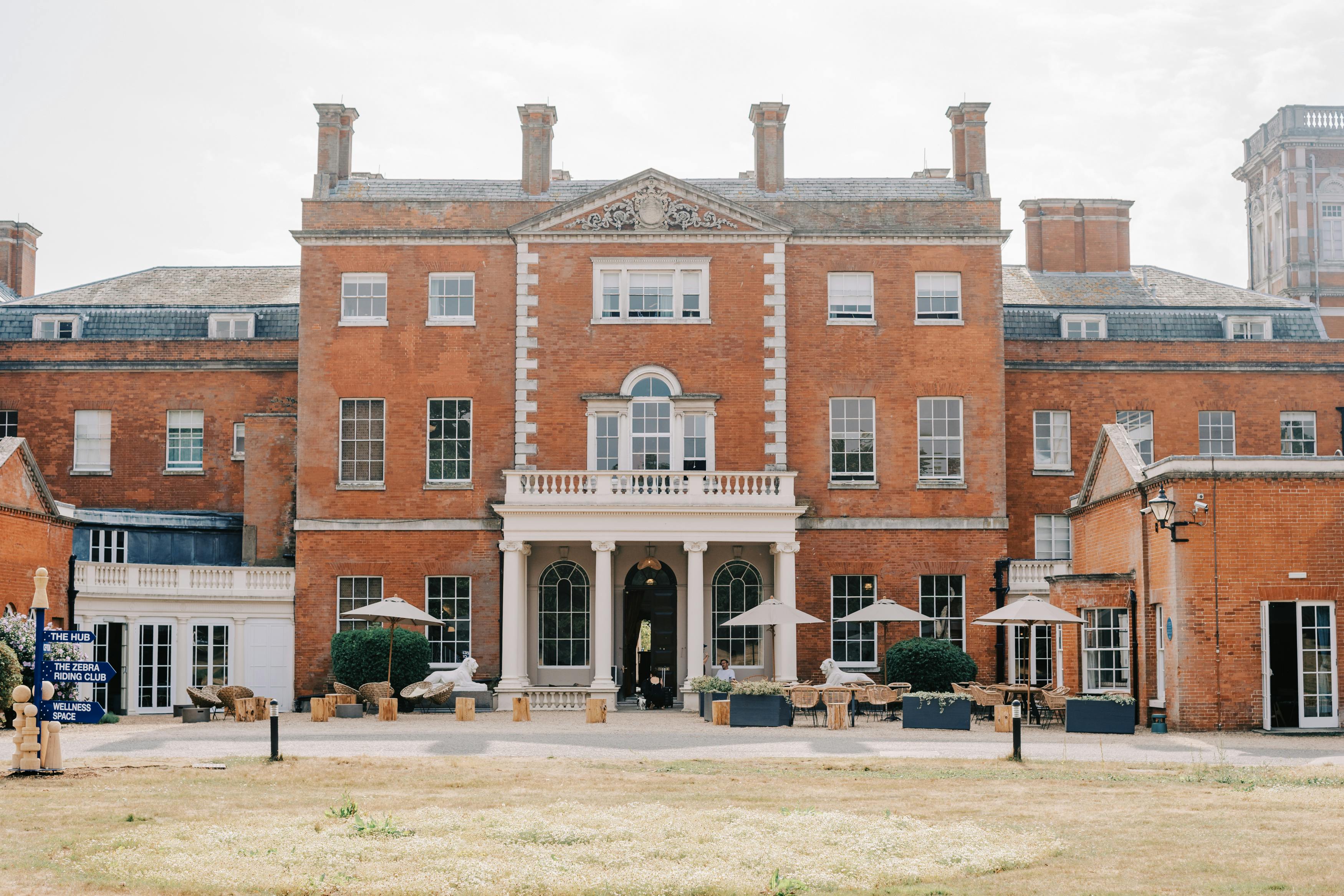 Evelyn at upscale venue with red brick facade, ideal for corporate events and gatherings.