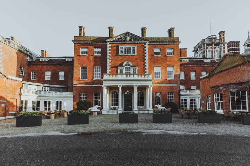 Evelyn in Birch Handle Silk Comet at an elegant red brick event venue.
