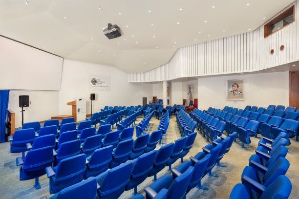 Lecture Theatre with tiered blue seating, ideal for conferences and seminars.