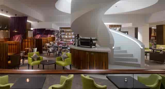 Lounge space with central staircase at Pavilion Kensington for executive networking and receptions.