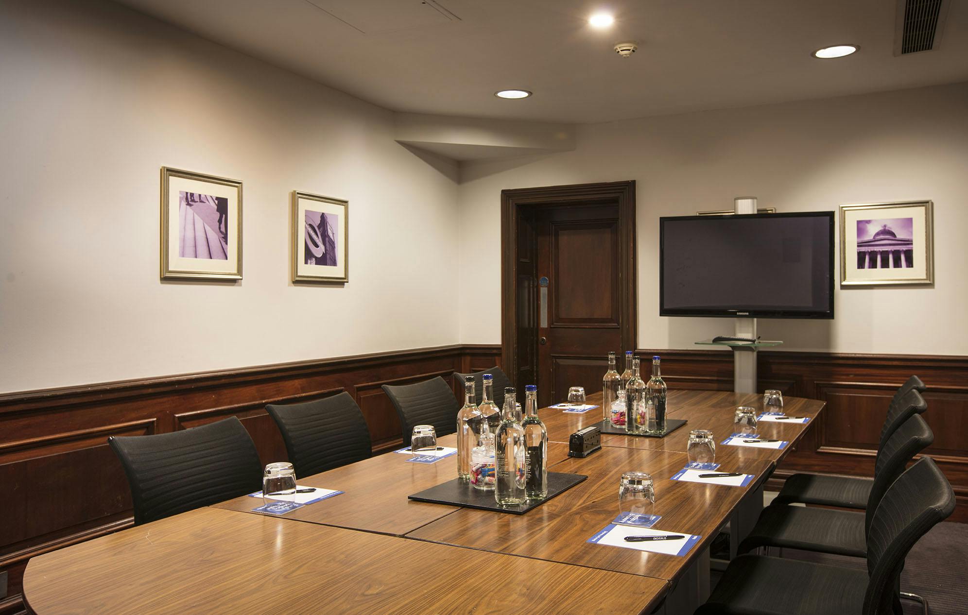 Boardroom in Thistle Holborn with sleek table, ideal for professional meetings and events.