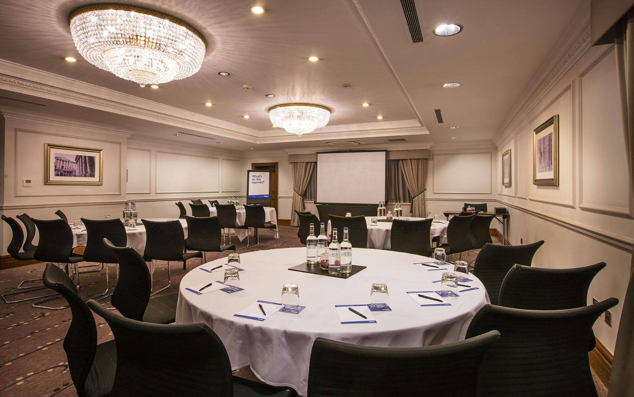 Meeting room at Albion Thistle Holborn with circular tables for professional events.