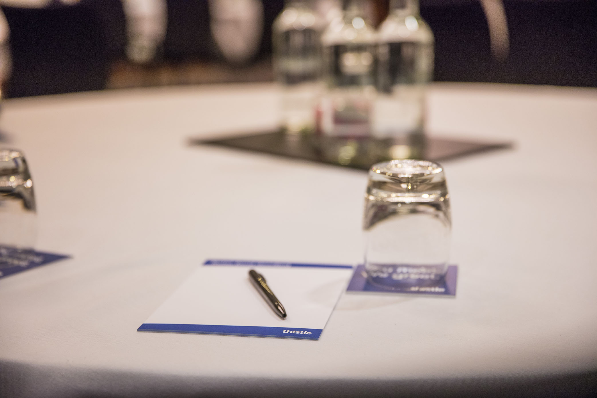 "Meeting setup at Albion Thistle Holborn with round table, water bottles, and notepads." - Banner