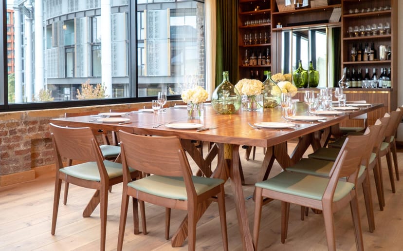 Private dining room with large wooden table, ideal for corporate meetings and private events.
