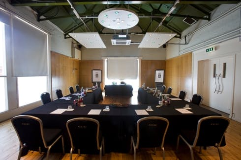 Bistro Cottage meeting room at O2 Academy Edinburgh, featuring a large table for professional events.