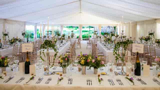 Elegant croquet lawn setup with floral centerpieces for weddings and corporate events.
