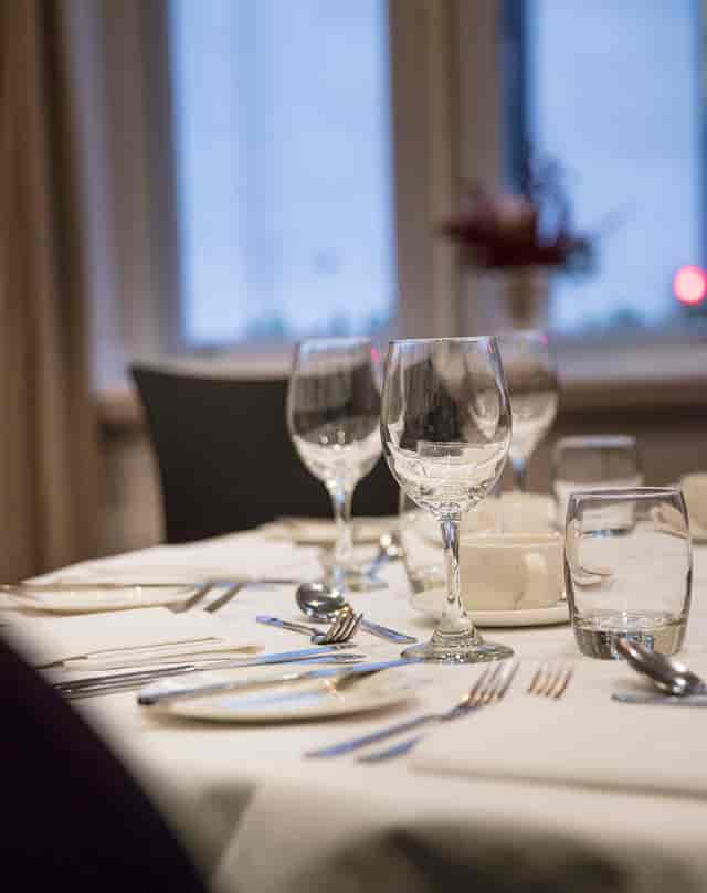 Elegant dining table setup with glassware for a formal corporate dinner event.