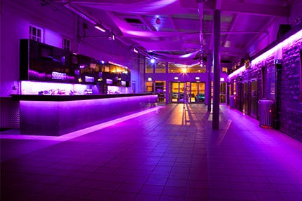 Modern event space at O2 Academy Edinburgh with vibrant purple lighting for parties.