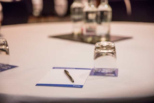 Meeting setup at Thackery in Thistle Holborn with round table, water bottles, and notepads.
