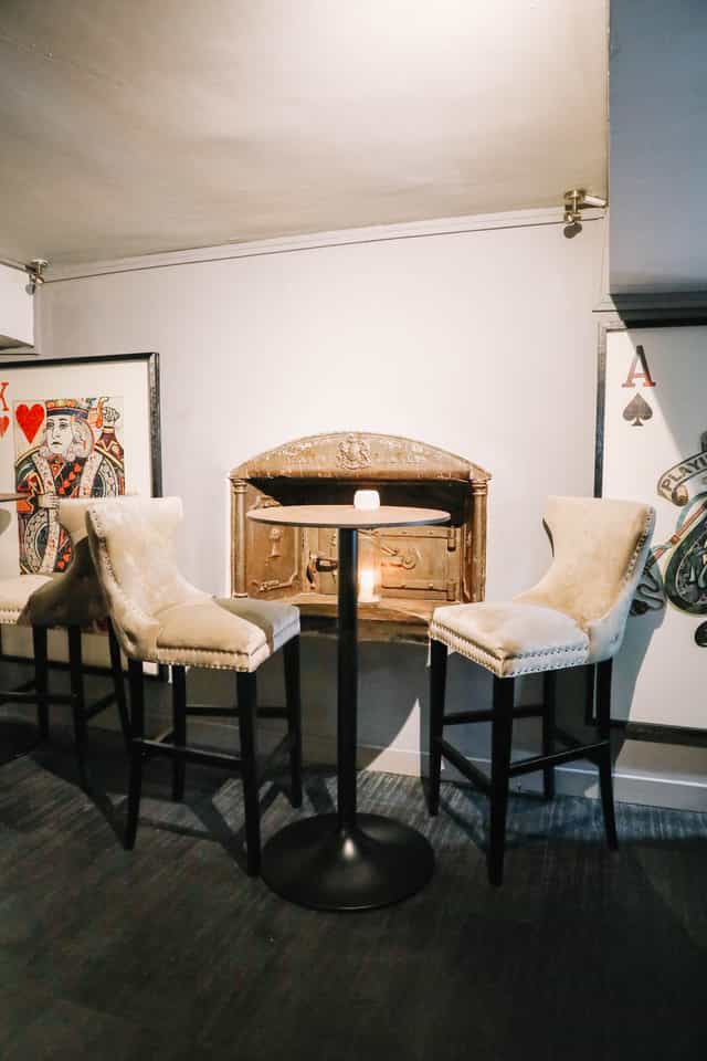 Intimate meeting space at Sandy's Piano Bar with plush chairs and artistic decor.