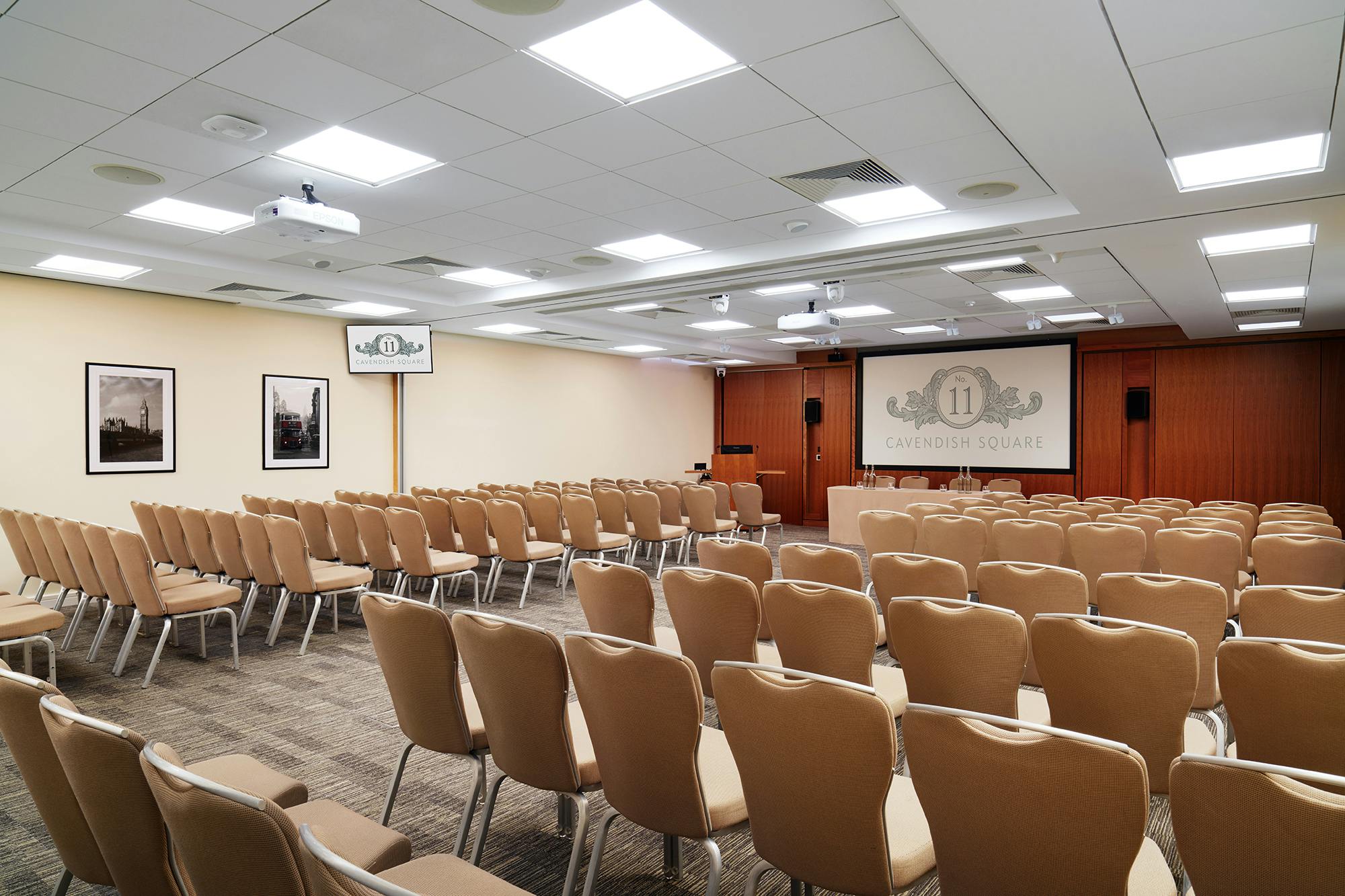 Maynard Theatre conference room with beige chairs, ideal for meetings and events.