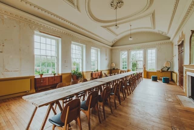 Spacious meeting room with large windows, ideal for workshops and corporate events.