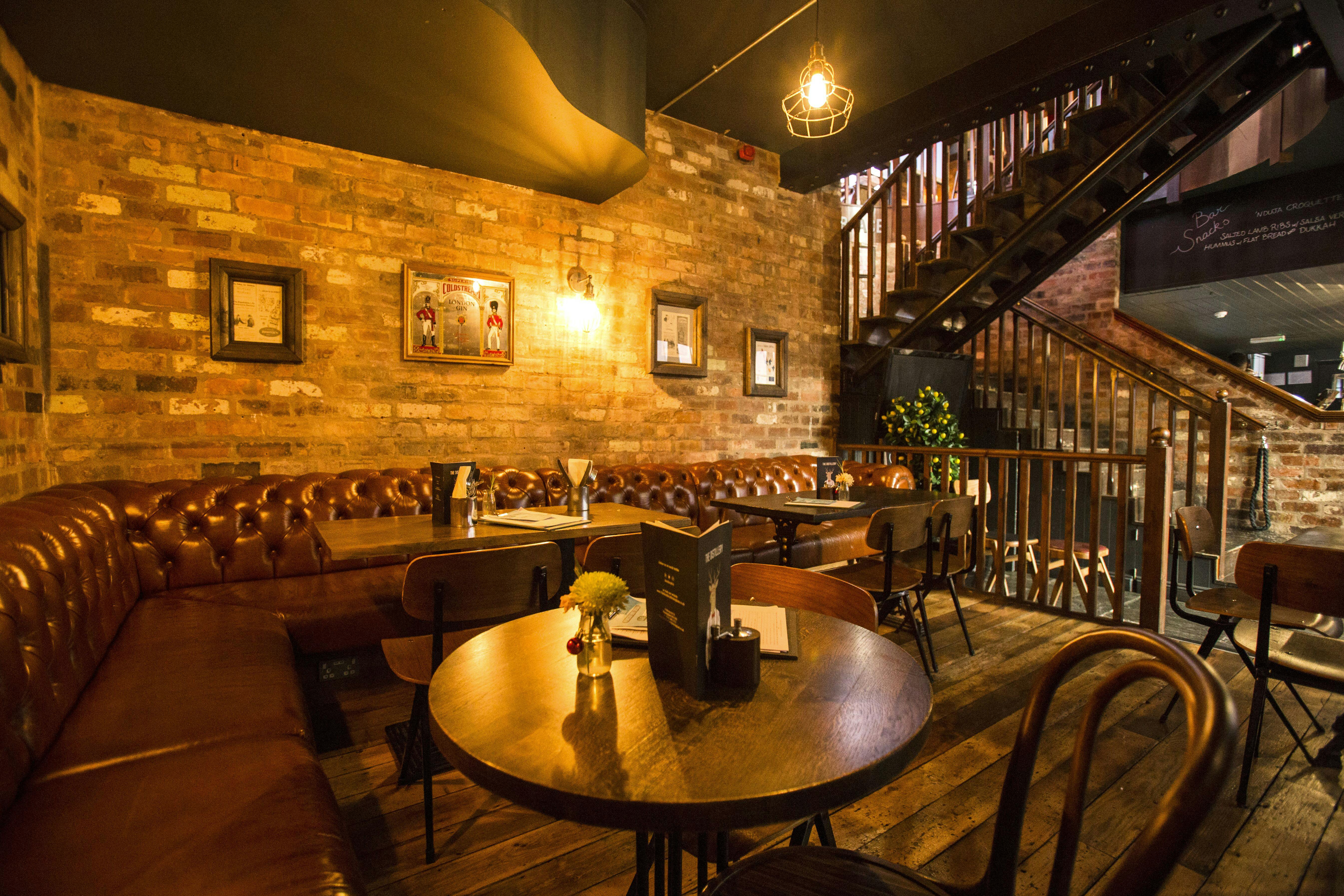 Cozy Gin Snug venue with rustic charm, perfect for intimate meetings and small events.