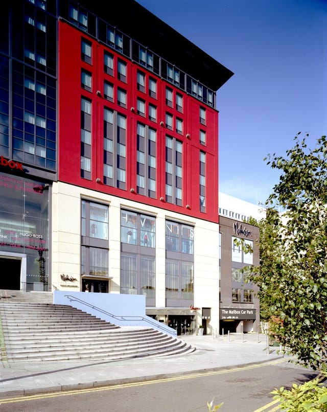 Modern event venue Work Play 6 in Birmingham with striking red facade and large windows.
