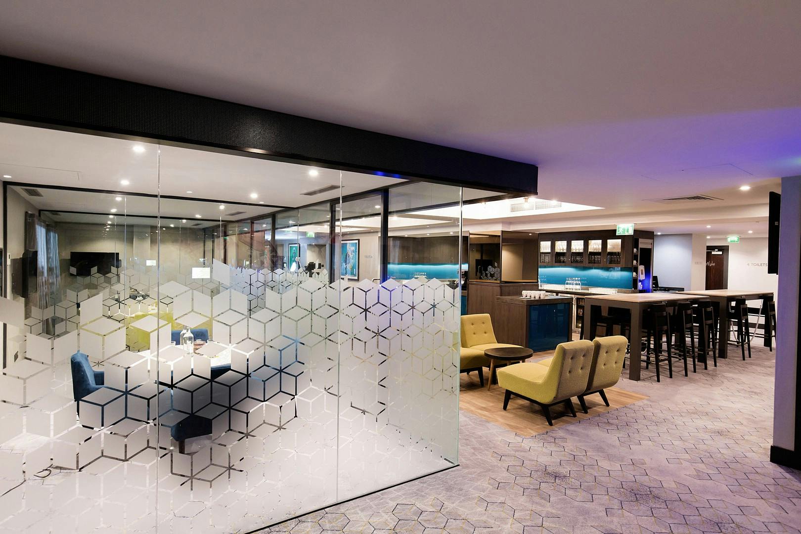 Modern meeting space in Malmaison Birmingham with glass walls, ideal for networking events.