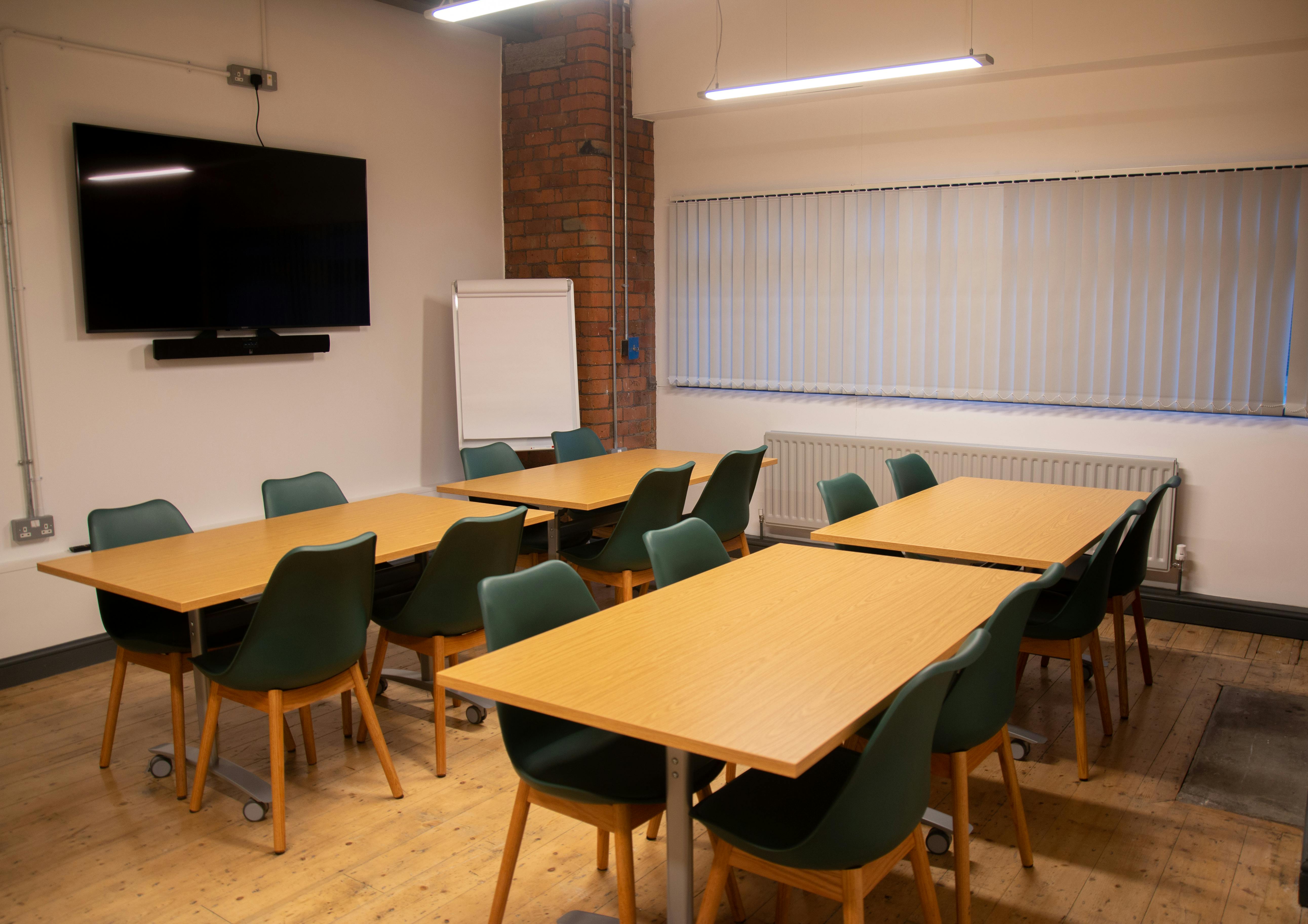 Achieve Room in Swan Buildings: flexible meeting space with large screen for events.