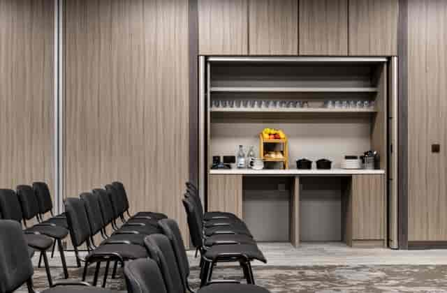 Modern AC Marriott Manchester meeting room with integrated breakout station for corporate events.