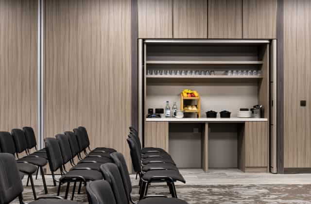 Modern AC Marriott Manchester meeting room with integrated breakout station for corporate events.