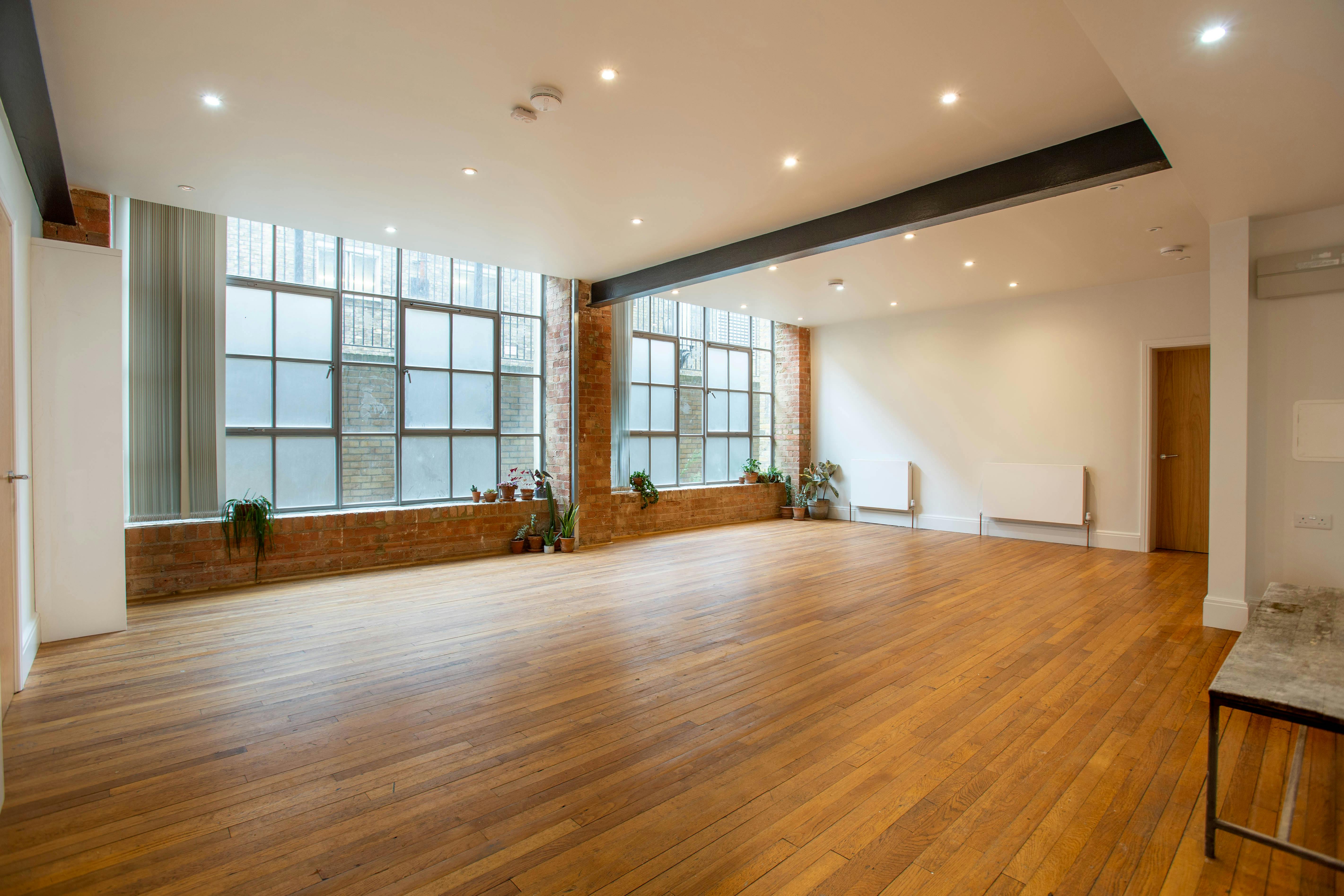 Spacious event space with large windows, ideal for workshops and networking sessions.