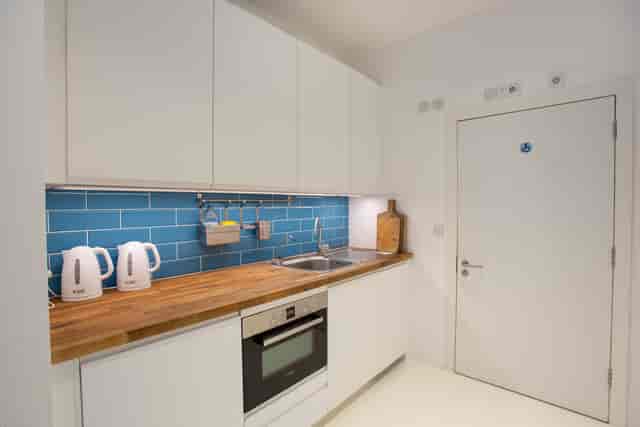 Modern kitchenette in Studio 52, featuring sleek cabinetry for events and meetings.